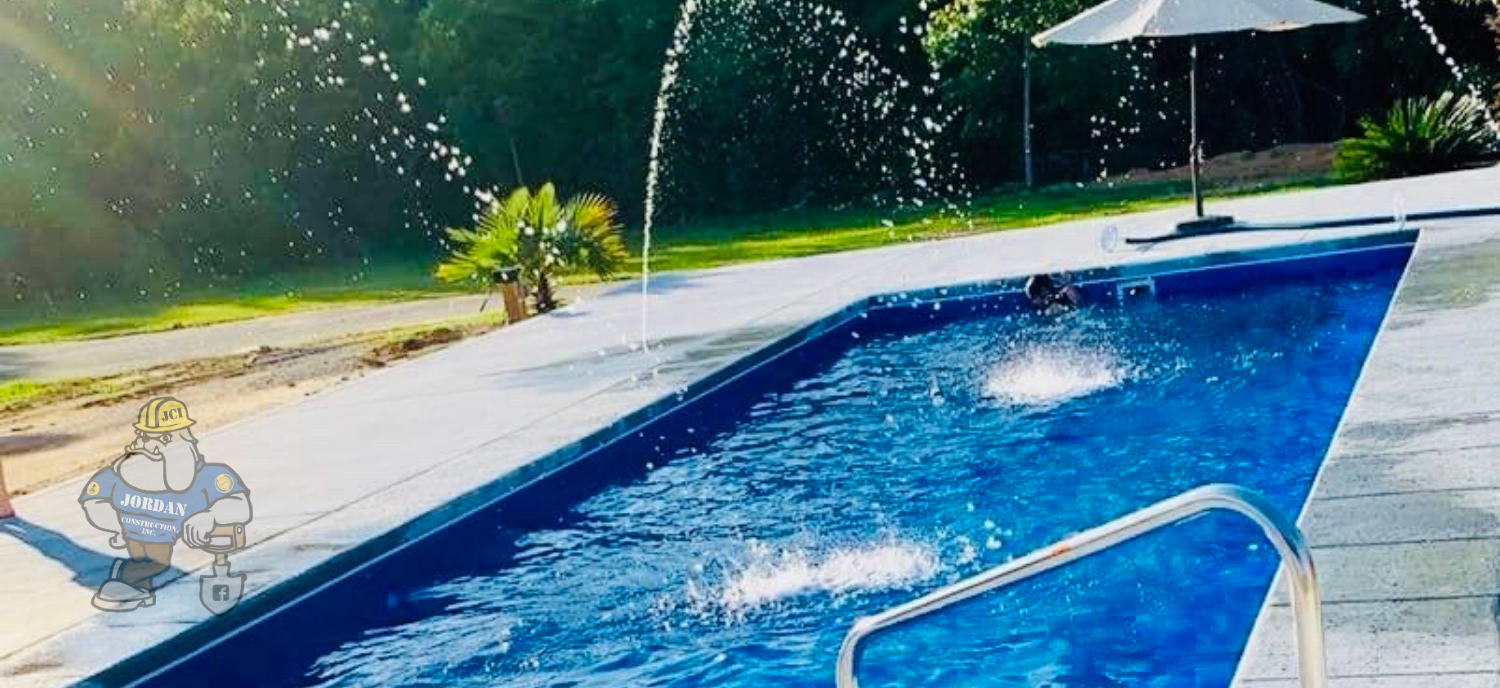 in-ground swimming pool with water fountain